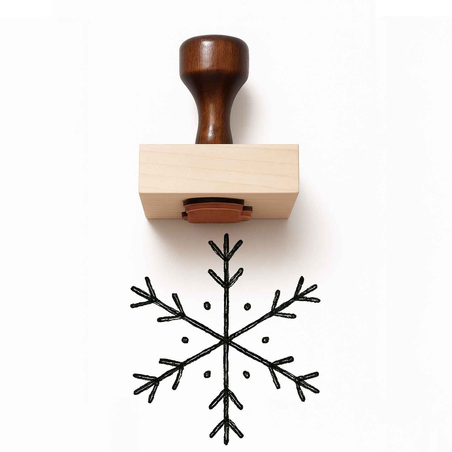 Wooden stamp with a snowflake design on a white background